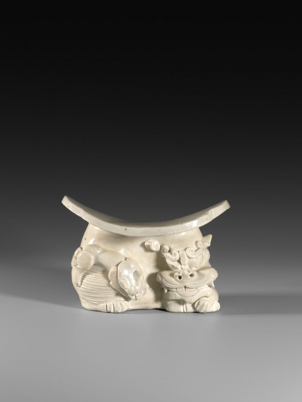 A YINGQING GLAZED PORCELAIN ‘LION’ PILLOW