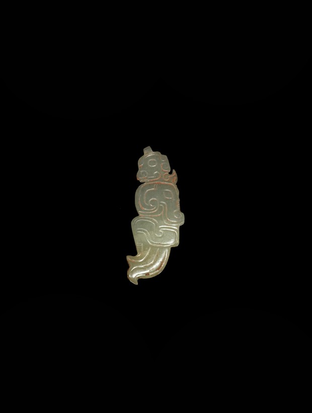 A WHITE JADE HUMAN HEAD AND DRAGON-FISH PENDANT